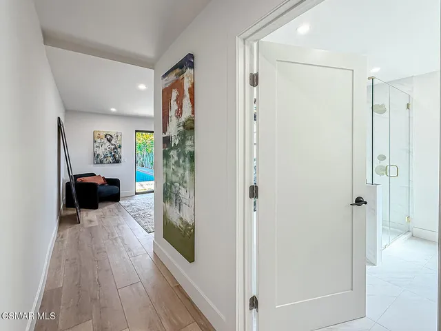 a white bath tub sitting in a bathroom and a shower