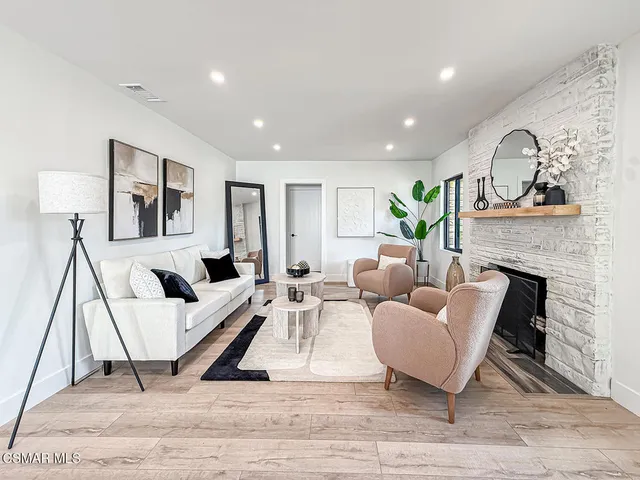 a living room with furniture and a fireplace