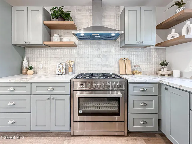 a stove top oven sitting inside of a kitchen