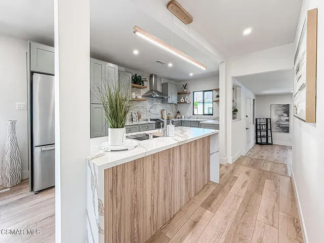 a kitchen with kitchen island a sink appliances and cabinets