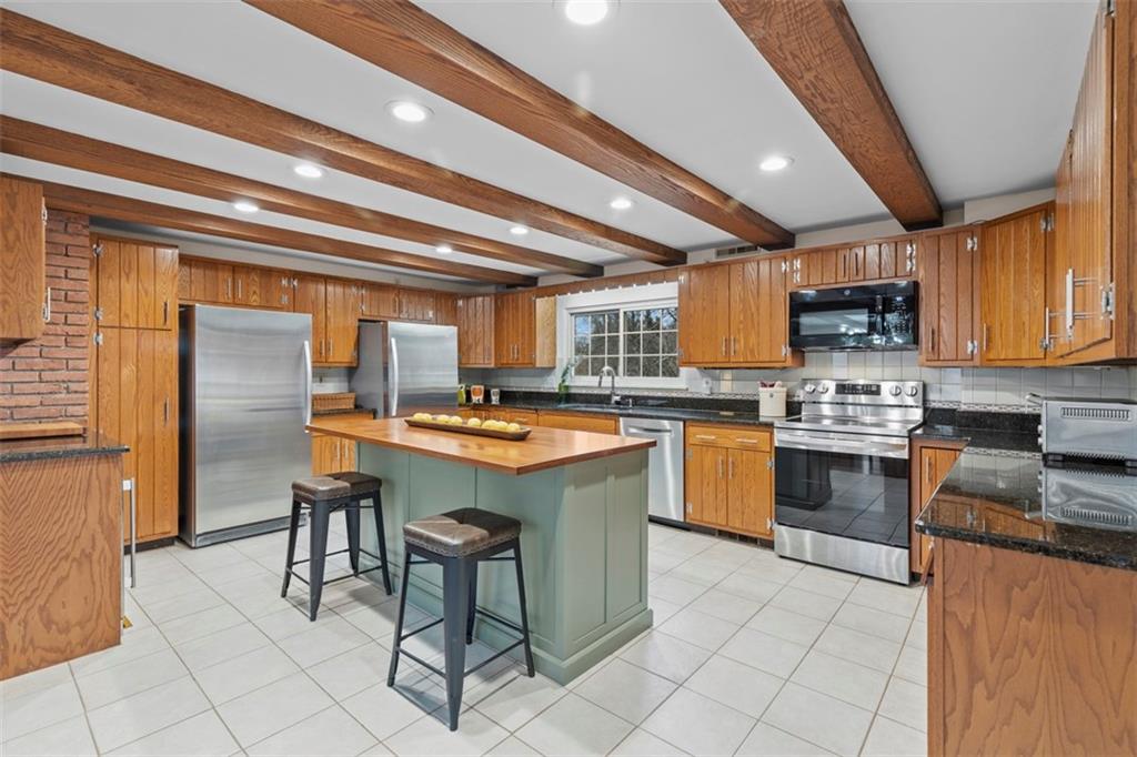85 Lambeth Drive Pittsburgh, PA 15241 - Photo 10 of 47 a kitchen with granite countertop a sink counter top space appliances and cabinets
