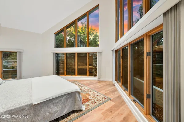 a bedroom with bed and wooden floor