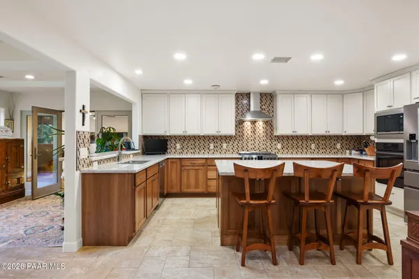 a kitchen with stainless steel appliances granite countertop a sink counter space and cabinets