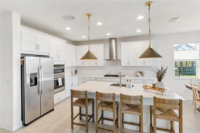 a living room with furniture kitchen view and a flat screen tv