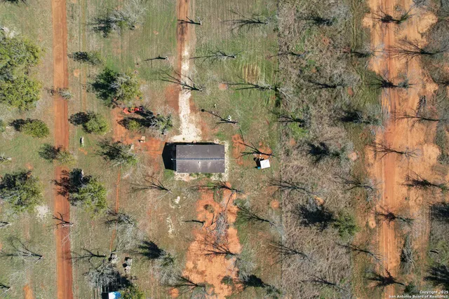 a aerial view of a house with a yard