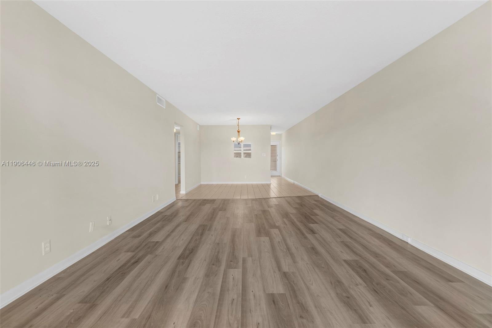 4401 Martinique Court, Unit C4 Coconut Creek, FL 33066 - Photo 17 of 26 a view of empty room with wooden floor