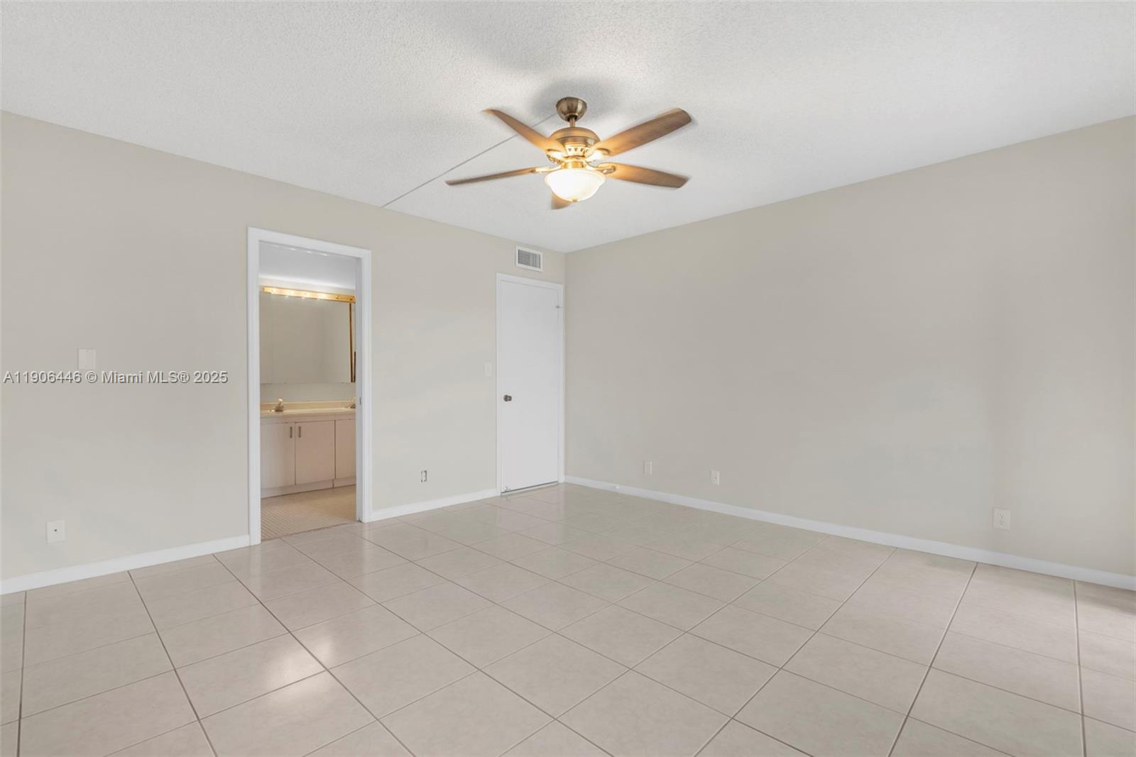 4401 Martinique Court, Unit C4 Coconut Creek, FL 33066 - Photo 19 of 26 a view of a livingroom with a ceiling fan and window