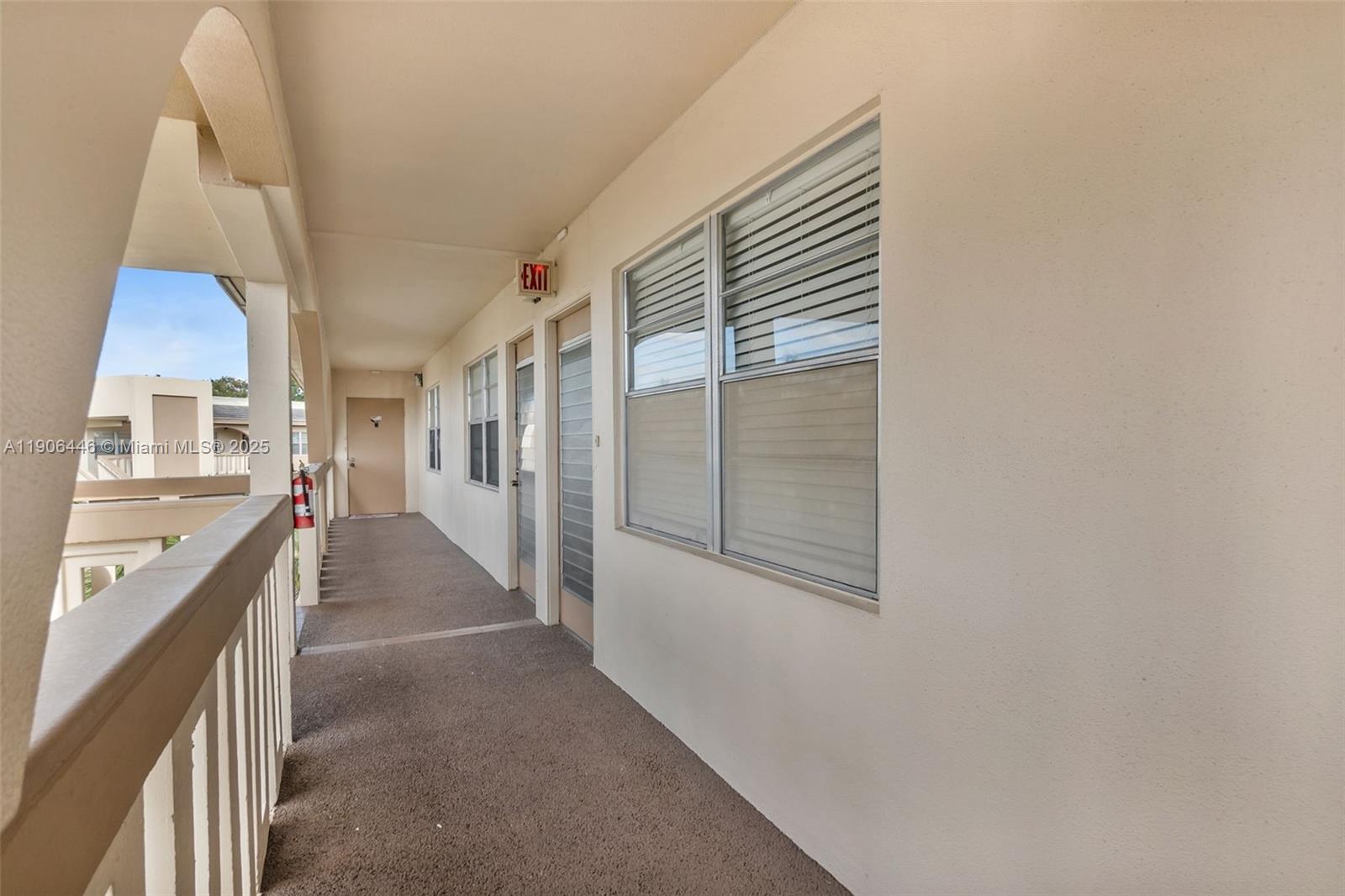 4401 Martinique Court, Unit C4 Coconut Creek, FL 33066 - Photo 25 of 26 a hallway with windows