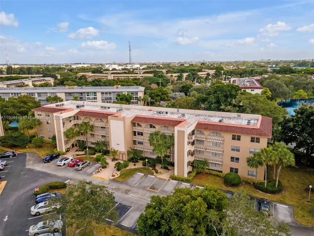 an aerial view of a building with garden space and street view