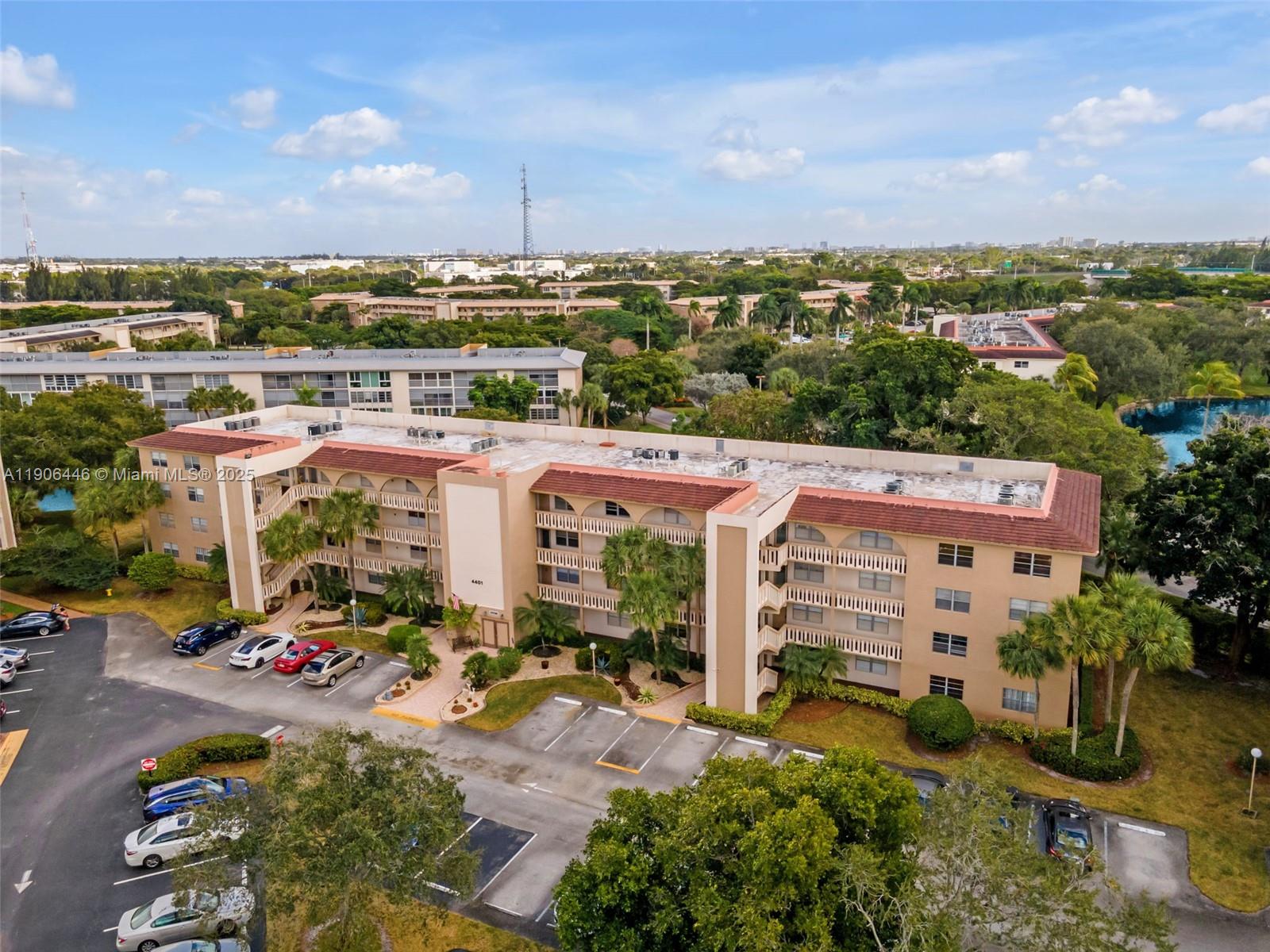 4401 Martinique Court, Unit C4 Coconut Creek, FL 33066 - Photo 26 of 26 an aerial view of a building with garden space and street view