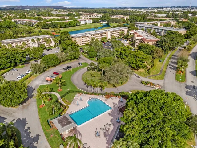 an aerial view of a city with lots of residential buildings ocean and mountain view