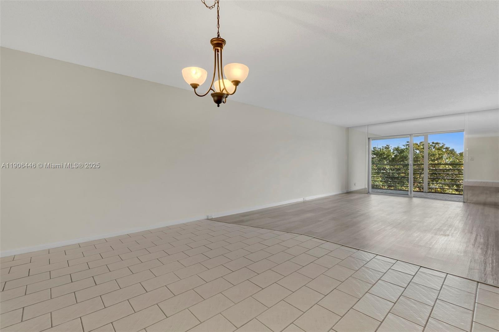 4401 Martinique Court, Unit C4 Coconut Creek, FL 33066 - Photo 8 of 26 an empty room with a empty space and chandelier fan