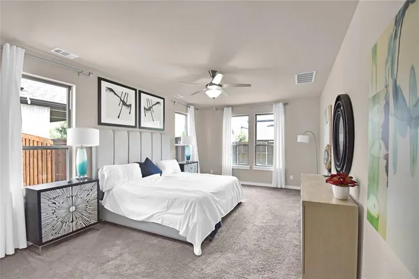 a bedroom with a bed couch and a window