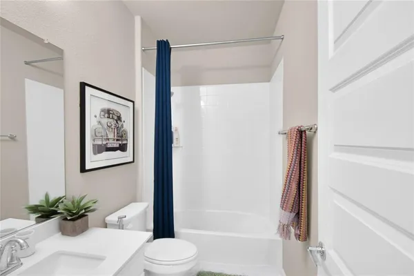 a bathroom with a shower a toilet and a sink