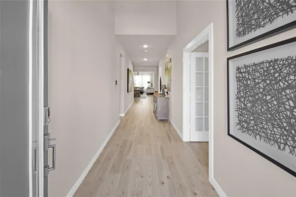 a view of a hallway with wooden floor