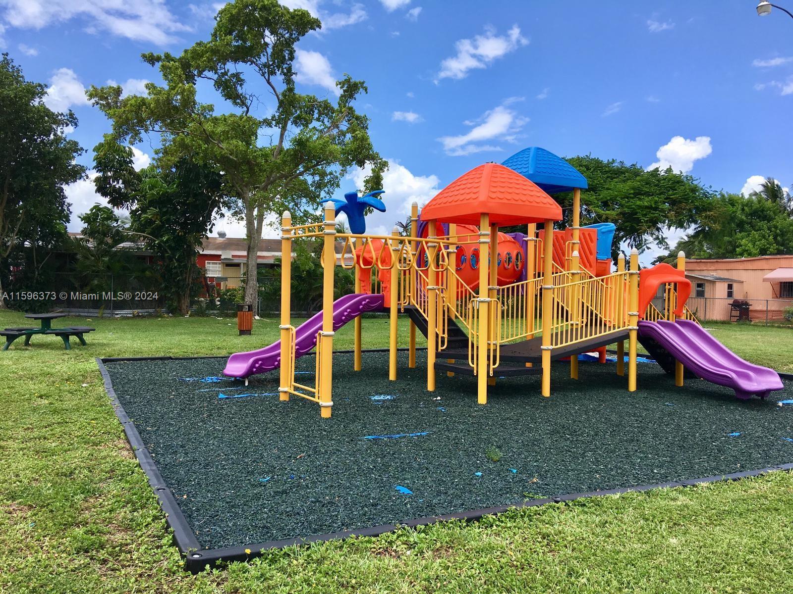 1432 Southwest 129th Court, Unit 2 Miami, FL 33184 - Photo 12 of 12 a view of outdoor space with playground and green space