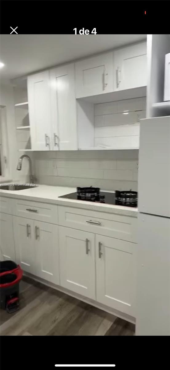 1432 Southwest 129th Court, Unit 2 Miami, FL 33184 - Photo 3 of 12 a kitchen with a sink and cabinets