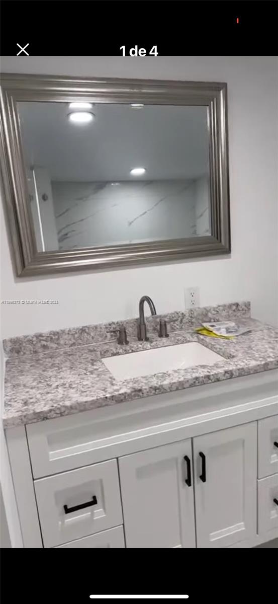 1432 Southwest 129th Court, Unit 2 Miami, FL 33184 - Photo 4 of 12 a view of sink and mirror