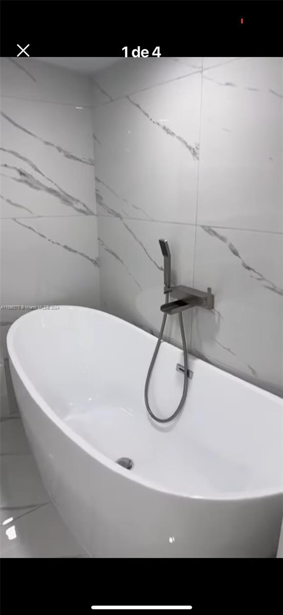 1432 Southwest 129th Court, Unit 2 Miami, FL 33184 - Photo 5 of 12 a bathroom with a sink