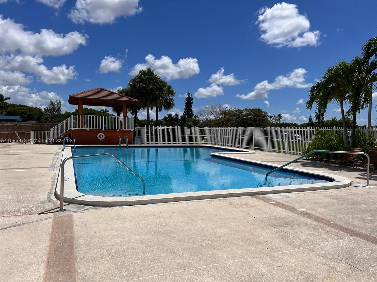 1432 Southwest 129th Court, Unit 2 Miami, FL 33184 - Photo 7 of 12 a view of a swimming pool with an outdoor seating