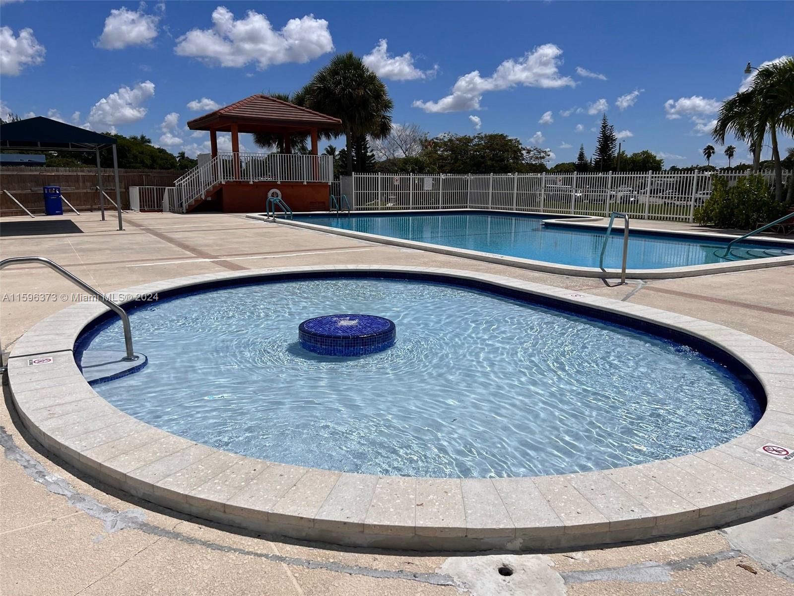 1432 Southwest 129th Court, Unit 2 Miami, FL 33184 - Photo 8 of 12 a view of swimming pool with lounge chair