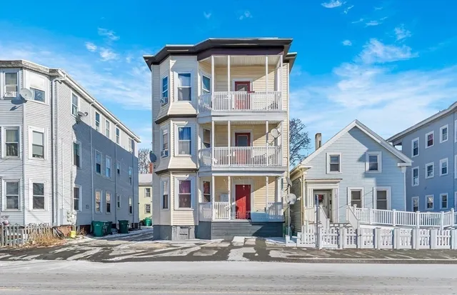 a front view of a residential apartment building with a street