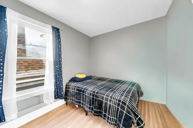 a bedroom with a bed and a window
