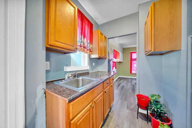 a kitchen with stainless steel appliances granite countertop a sink and a refrigerator