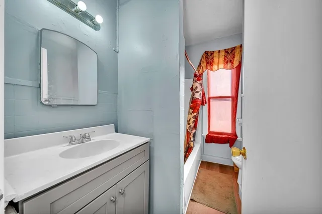 a bathroom with a sink and a mirror