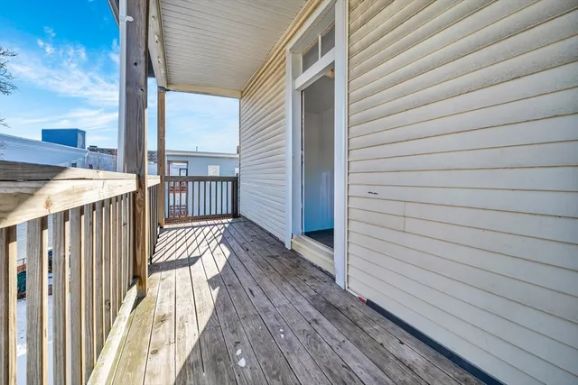 a view of a balcony with wooden floor