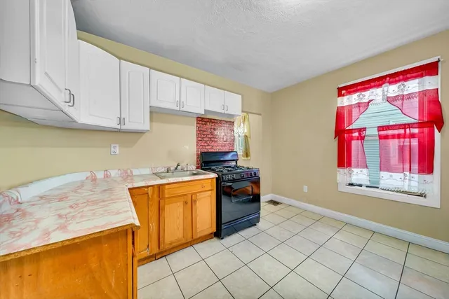 a kitchen with stainless steel appliances granite countertop a sink and a stove