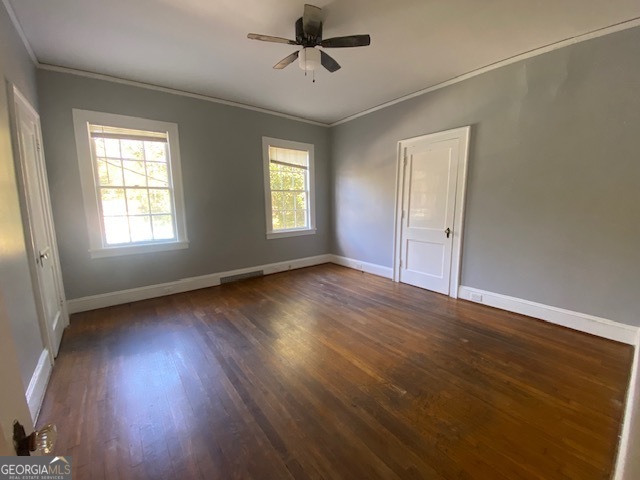 311 East 4th Street West Point, GA 31833 - Photo 15 of 32 a view of an empty room with wooden floor and a window