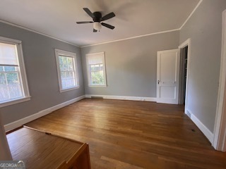 311 East 4th Street West Point, GA 31833 - Photo 16 of 32 a view of an empty room with wooden floor and a window