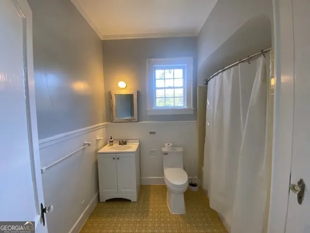 a bathroom with a sink toilet and mirror