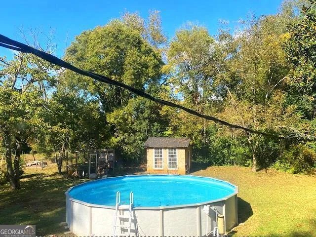 a view of a swimming pool with a yard