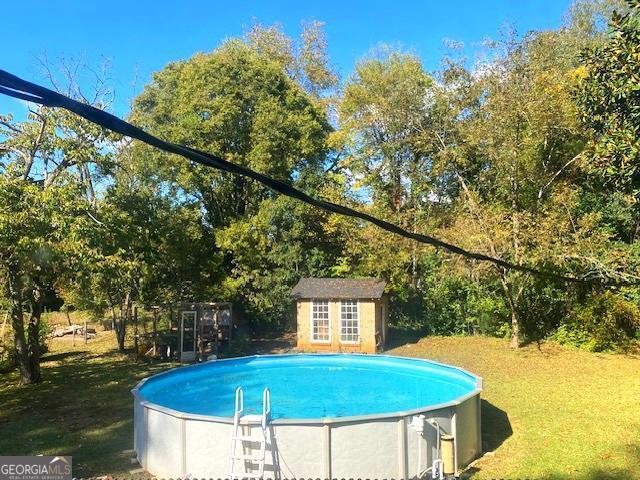 311 East 4th Street West Point, GA 31833 - Photo 22 of 32 a view of a swimming pool with a yard