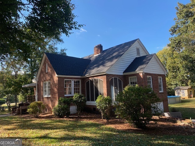 311 East 4th Street West Point, GA 31833 - Photo 3 of 32 a front view of a house with a yard