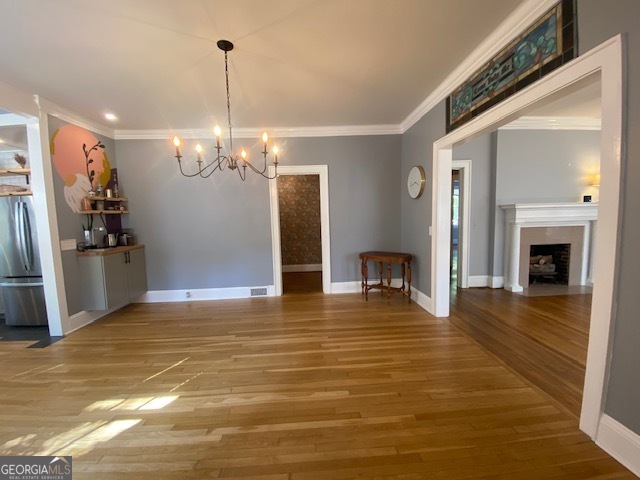 311 East 4th Street West Point, GA 31833 - Photo 5 of 32 a view of a livingroom with a fireplace a chandelier and wooden floor