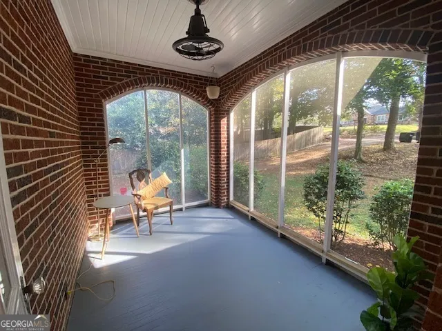 a view of a porch with chairs and backyard