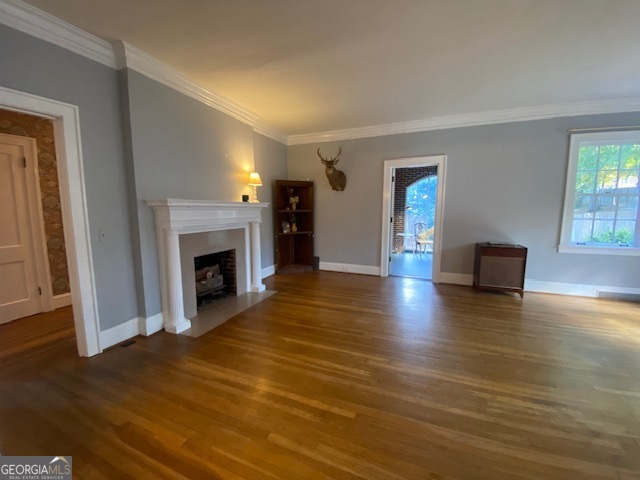 311 East 4th Street West Point, GA 31833 - Photo 10 of 32 a view of a livingroom with wooden floor and a fireplace