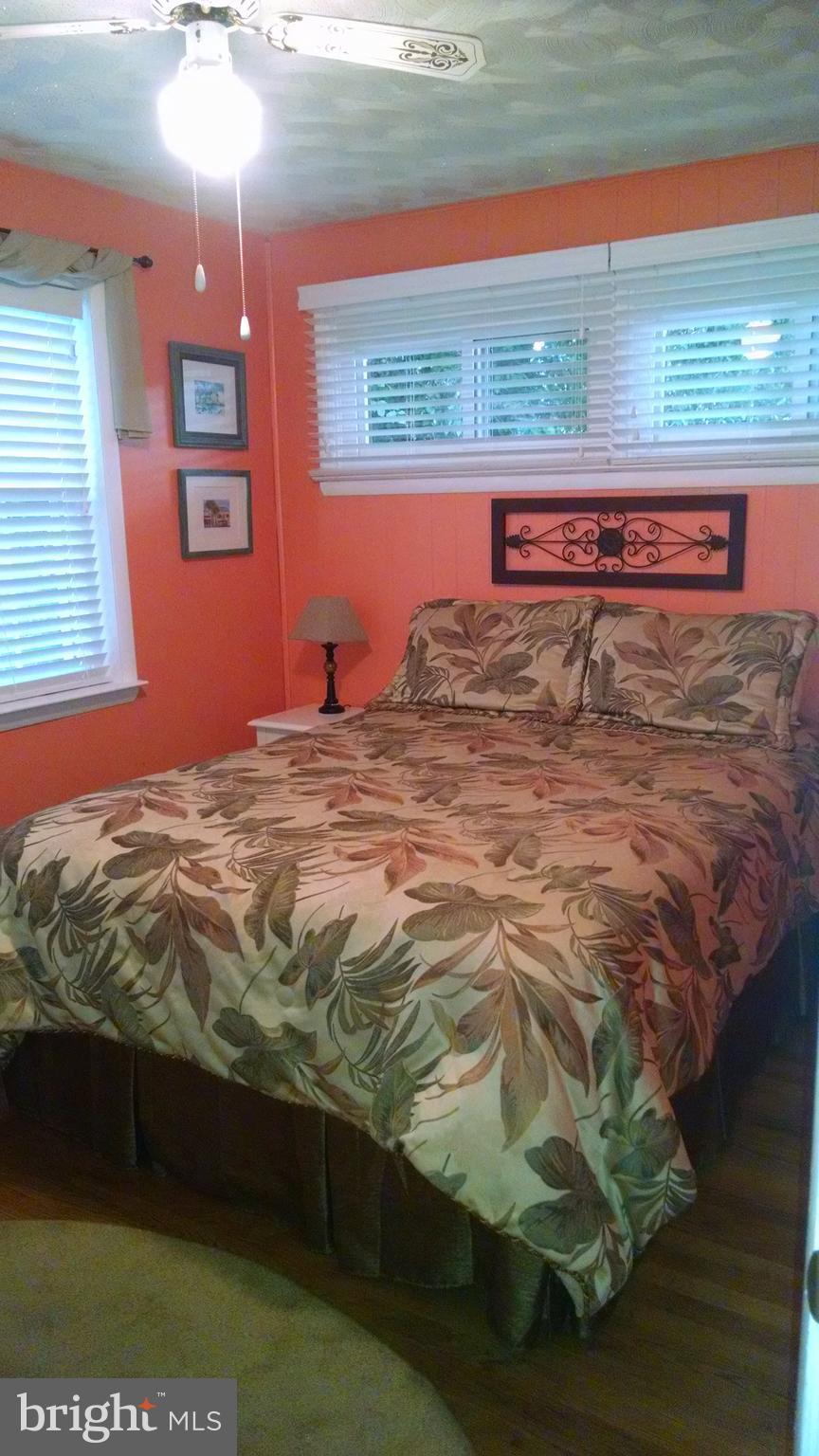1229 Seneca Road Baltimore, MD 21220 - Photo 17 of 23 a bed sitting in a bedroom next to a window