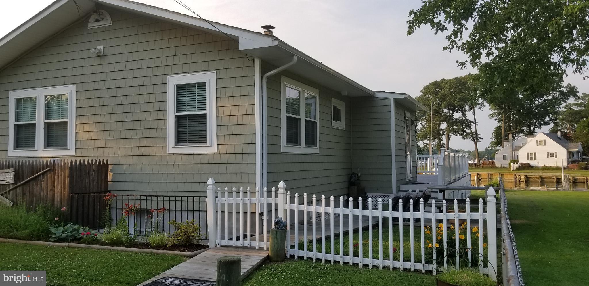 1229 Seneca Road Baltimore, MD 21220 - Photo 21 of 23 a front view of a house with a garden