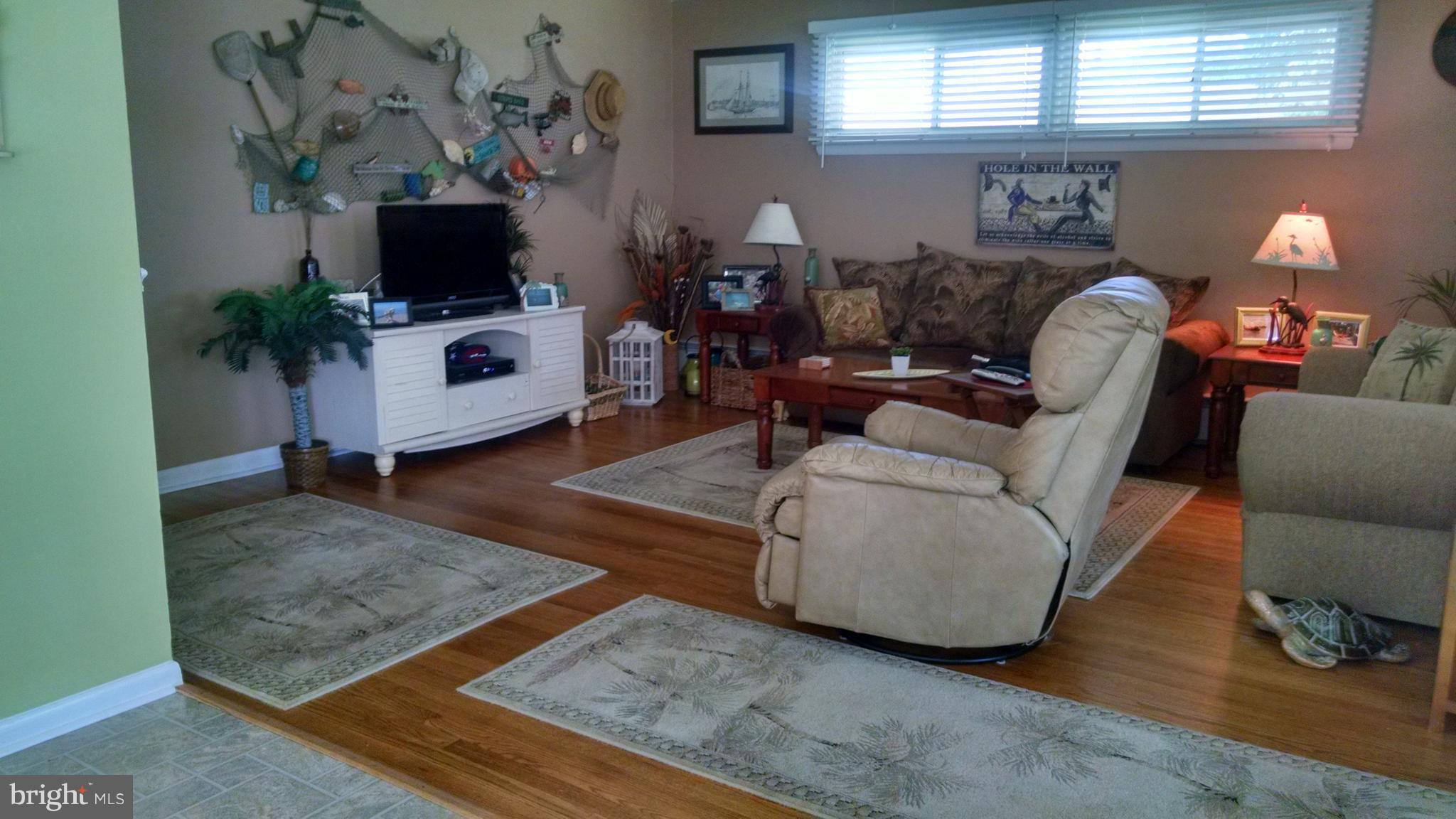 1229 Seneca Road Baltimore, MD 21220 - Photo 7 of 23 a living room with furniture and a flat screen tv