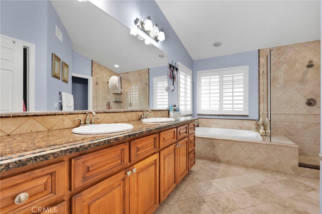 17777 Brazier Drive Riverside, CA 92508 - Photo 7 of 55 a spacious bathroom with a granite countertop double vanity sink a mirror and a bathtub