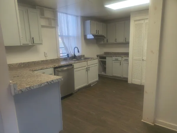 a kitchen with a sink stove and cabinets