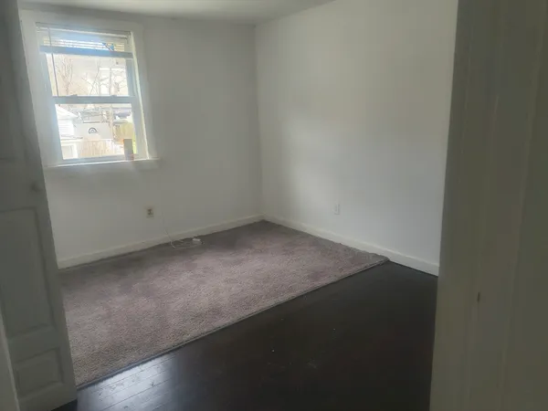 a bathroom with a sink toilet and window