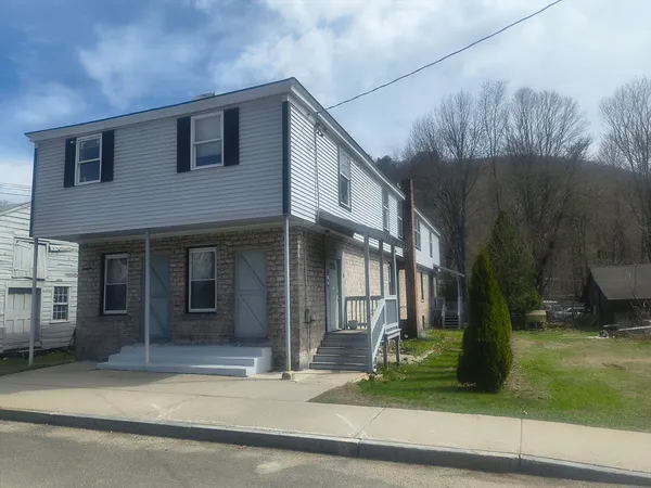 a front view of a house with a yard