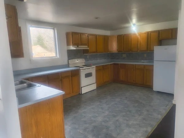 a kitchen with a sink stove and refrigerator