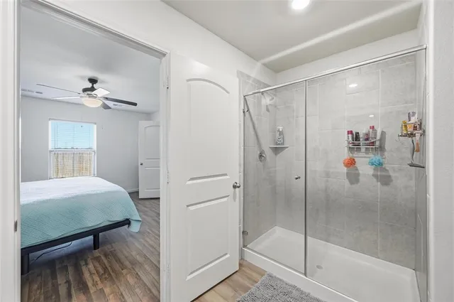 a bathroom with a shower and a sink