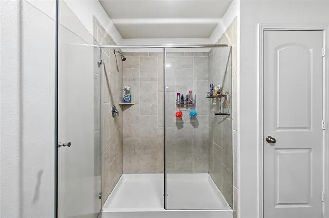 a bathroom with a glass shower door